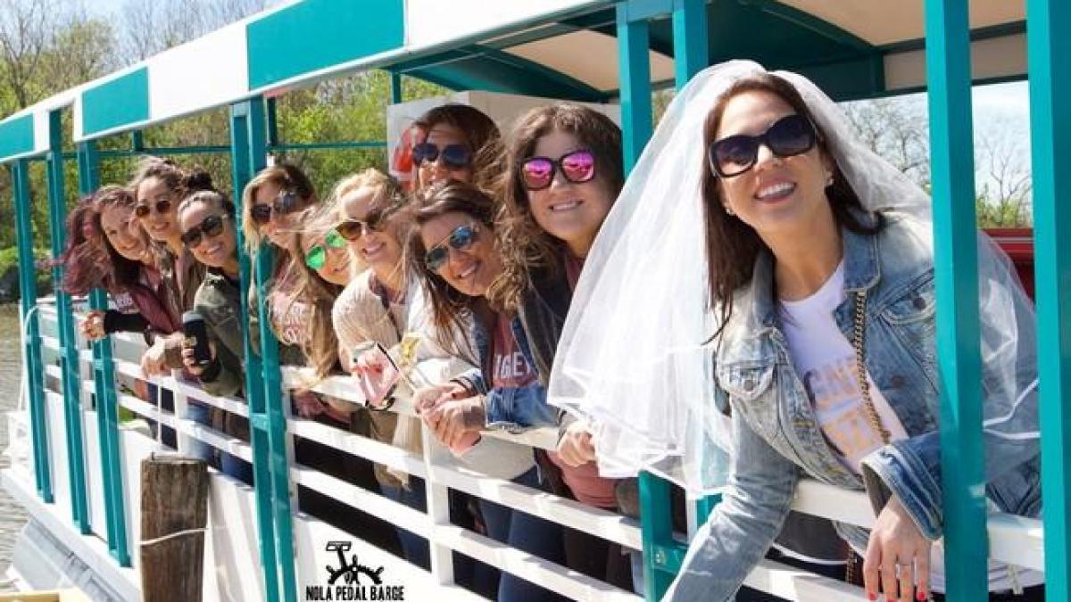 a group of people standing next to a fence